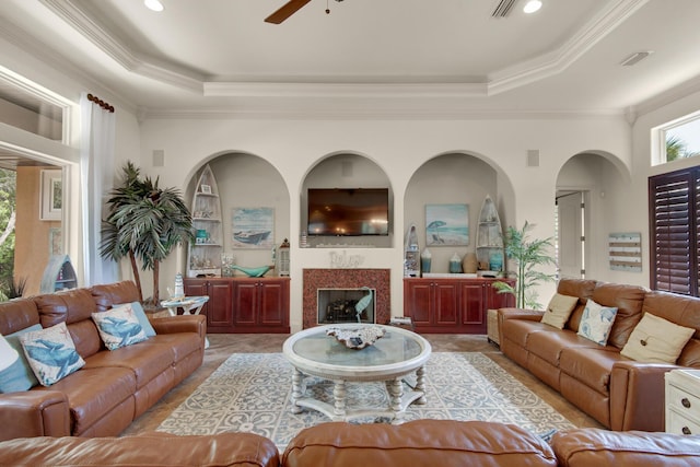 4701 Seastar Vis, Destin, FL 32541 - living area featuring a raised ceiling, ceiling fan, crown molding, a fireplace, and light tile patterned floors