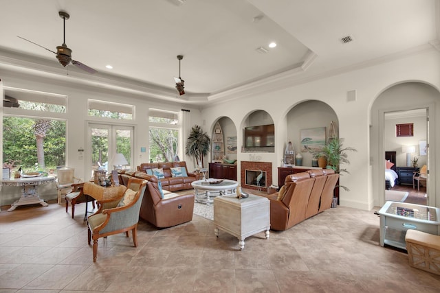 4701 Seastar Vis, Destin, FL 32541 - living area featuring crown molding, a ceiling fan, a raised ceiling, a glass covered fireplace, and recessed lighting