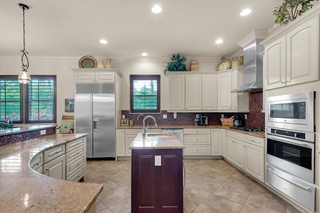 4701 Seastar Vis, Destin, FL 32541 - kitchen with built in appliances, a warming drawer, a center island with sink, a sink, and wall chimney exhaust hood