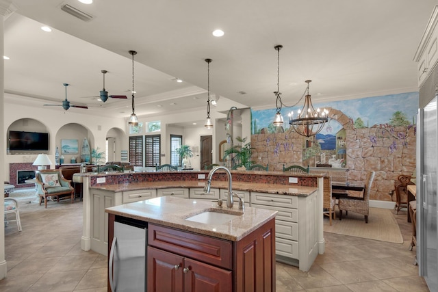 4701 Seastar Vis, Destin, FL 32541 - kitchen with a sink, a large island with sink, open floor plan, crown molding, and light tile patterned floors
