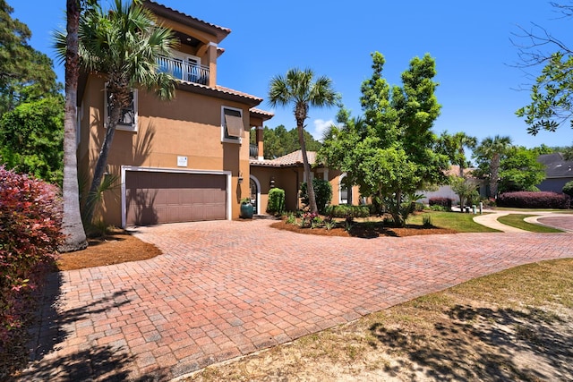 4701 Seastar Vis, Destin, FL 32541 - mediterranean / spanish-style house with a tiled roof, a garage, stucco siding, a balcony, and decorative driveway