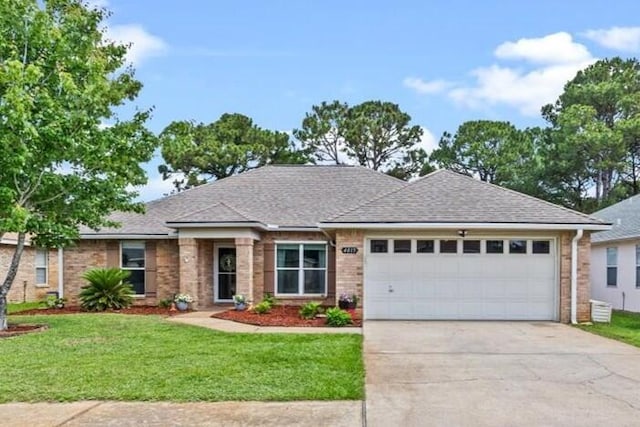 view of front facade with brick siding, a garage, concrete driveway, a front yard, and roof with shingles