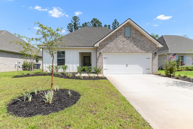 27 Cozy Cv, Freeport, FL 32439 - view of front of home featuring a garage, board and batten siding, brick siding, driveway, and a front lawn