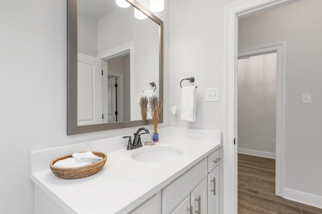 27 Cozy Cv, Freeport, FL 32439 - bathroom featuring vanity, wood finished floors, and baseboards