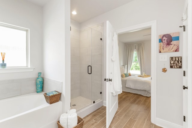 27 Cozy Cv, Freeport, FL 32439 - bathroom with ensuite bath, a bath, a shower stall, wood finished floors, and recessed lighting