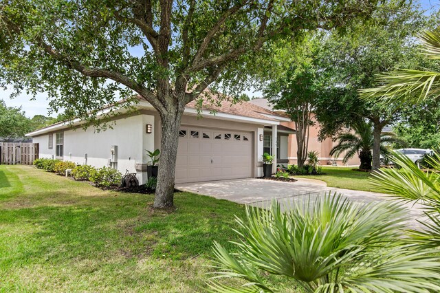 137 Loblolly Bay Dr, Santa Rosa Beach, FL 32459 - view of front of house featuring driveway, stucco siding, and an attached garage