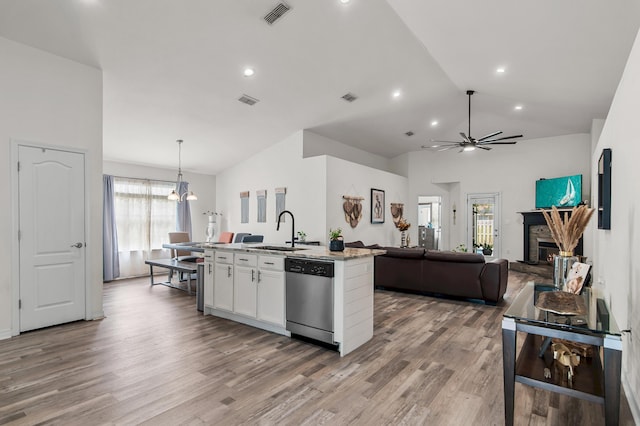 137 Loblolly Bay Dr, Santa Rosa Beach, FL 32459 - kitchen with dishwasher, a sink, open floor plan, lofted ceiling, and white cabinetry