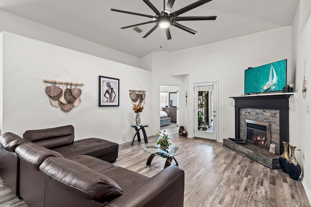137 Loblolly Bay Dr, Santa Rosa Beach, FL 32459 - living area with ceiling fan, wood finished floors, a stone fireplace, and baseboards