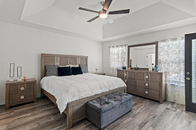 137 Loblolly Bay Dr, Santa Rosa Beach, FL 32459 - bedroom with wood finished floors, a raised ceiling, and a ceiling fan