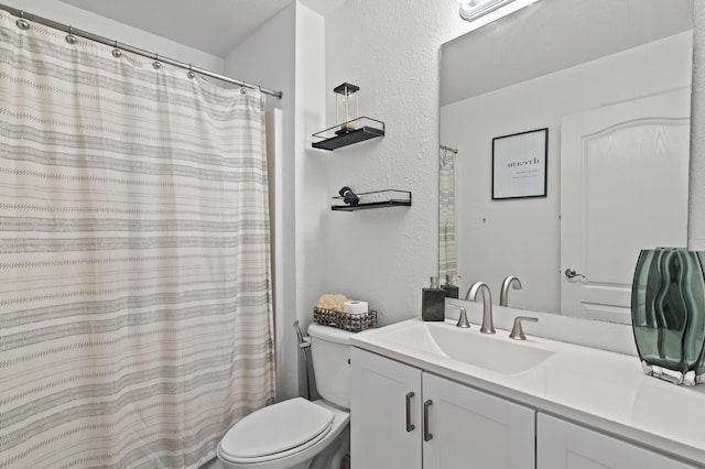 137 Loblolly Bay Dr, Santa Rosa Beach, FL 32459 - bathroom featuring a textured wall, toilet, vanity, and a shower with shower curtain