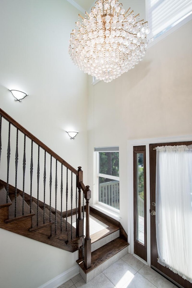 95 Bluebell Cir, Santa Rosa Beach, FL 32459 - entryway with a chandelier, stairway, and a high ceiling