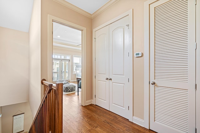 6236 Thomas Dr, Panama City Beach, FL 32408 - corridor featuring dark wood finished floors, crown molding, an upstairs landing, and baseboards
