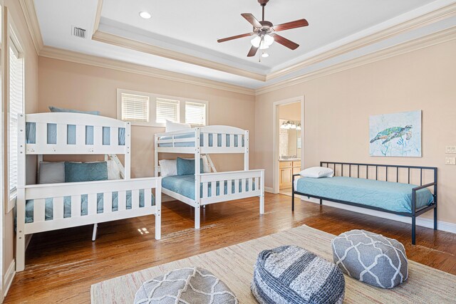6236 Thomas Dr, Panama City Beach, FL 32408 - bedroom featuring a tray ceiling, wood finished floors, crown molding, and recessed lighting