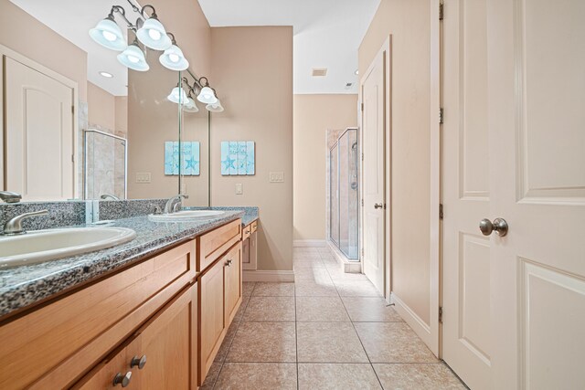 6236 Thomas Dr, Panama City Beach, FL 32408 - bathroom with a stall shower, tile patterned flooring, double vanity, and baseboards