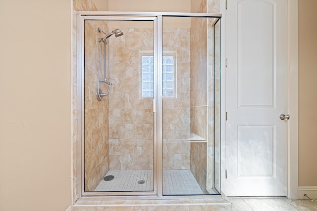 6236 Thomas Dr, Panama City Beach, FL 32408 - full bathroom featuring a stall shower, baseboards, and tile patterned flooring