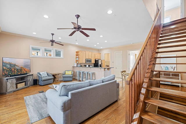 6236 Thomas Dr, Panama City Beach, FL 32408 - living area with stairs, ornamental molding, ceiling fan, recessed lighting, and light wood-style flooring