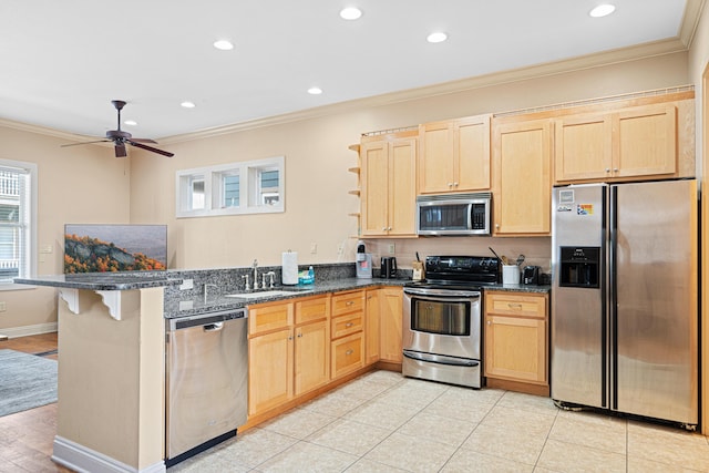 6236 Thomas Dr, Panama City Beach, FL 32408 - kitchen featuring stainless steel appliances, ornamental molding, a sink, light brown cabinets, and a peninsula
