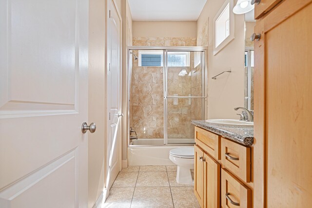 6236 Thomas Dr, Panama City Beach, FL 32408 - full bath featuring toilet, vanity, tile patterned floors, and shower / bath combination with glass door