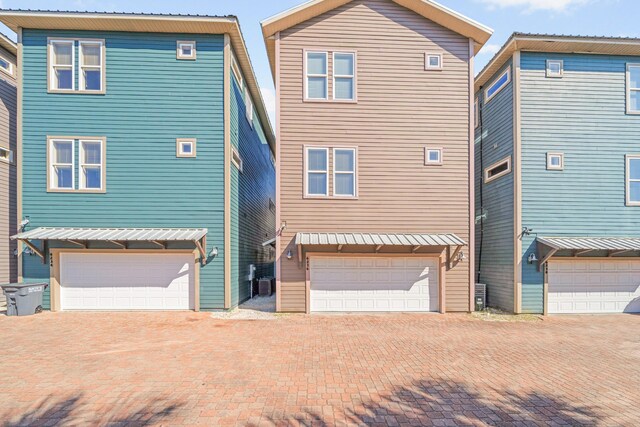 6236 Thomas Dr, Panama City Beach, FL 32408 - back of house with a garage and decorative driveway