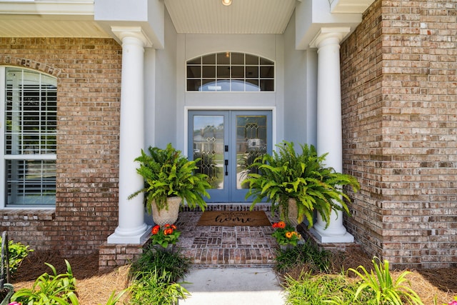 2009 Kildare Cir, Niceville, FL 32578 - property entrance featuring french doors, brick siding, and stucco siding