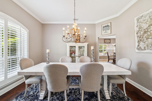 2009 Kildare Cir, Niceville, FL 32578 - dining area featuring a chandelier, crown molding, baseboards, and dark wood-type flooring