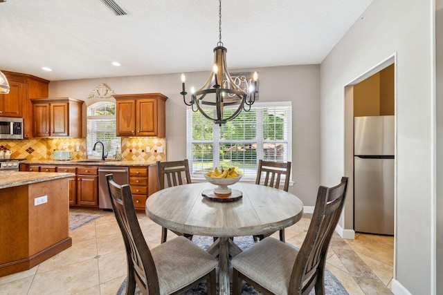 2009 Kildare Cir, Niceville, FL 32578 - dining area featuring a chandelier, plenty of natural light, recessed lighting, and light tile patterned floors