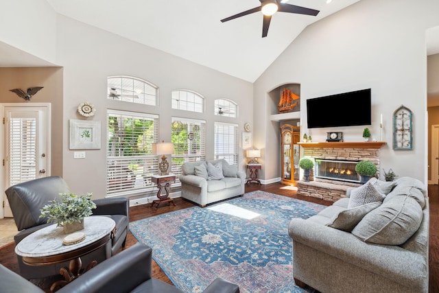 2009 Kildare Cir, Niceville, FL 32578 - living area featuring high vaulted ceiling, ceiling fan, wood finished floors, a stone fireplace, and baseboards