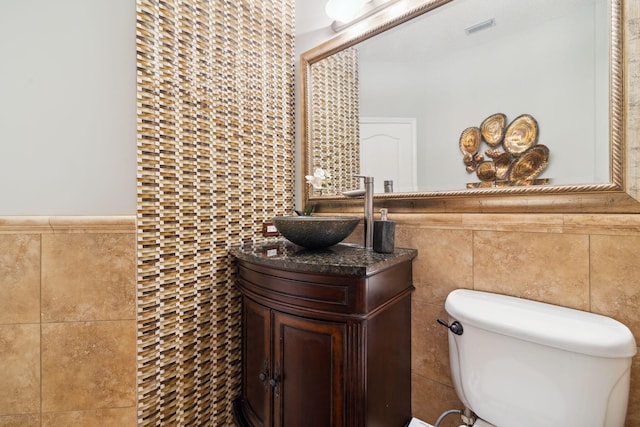 2009 Kildare Cir, Niceville, FL 32578 - half bath with tile walls, vanity, toilet, and a wainscoted wall