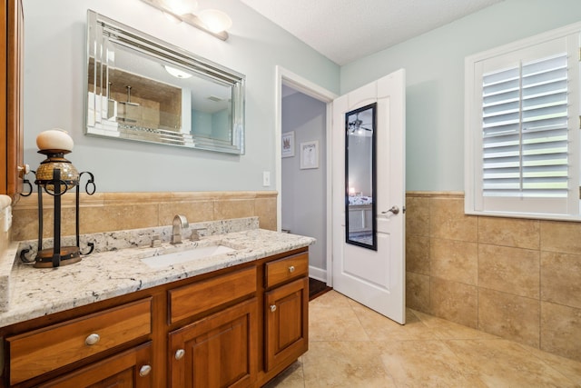 2009 Kildare Cir, Niceville, FL 32578 - bathroom featuring tile walls, tile patterned flooring, vanity, and wainscoting