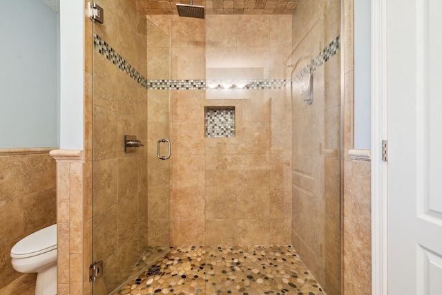 2009 Kildare Cir, Niceville, FL 32578 - bathroom with a shower stall, tile walls, a wainscoted wall, and toilet