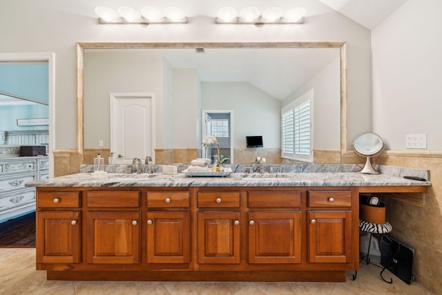 2009 Kildare Cir, Niceville, FL 32578 - full bath featuring lofted ceiling, double vanity, wainscoting, and tile patterned flooring