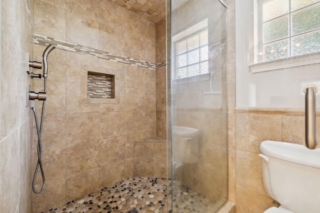 2009 Kildare Cir, Niceville, FL 32578 - full bathroom featuring a shower stall, toilet, and tile walls
