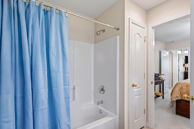 2424 Pineneedle Dr, Navarre, FL 32566 - ensuite bathroom featuring shower / tub combo with curtain and a textured ceiling