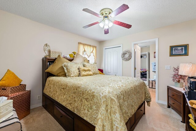2424 Pineneedle Dr, Navarre, FL 32566 - bedroom featuring light carpet, a closet, ceiling fan, and a textured ceiling