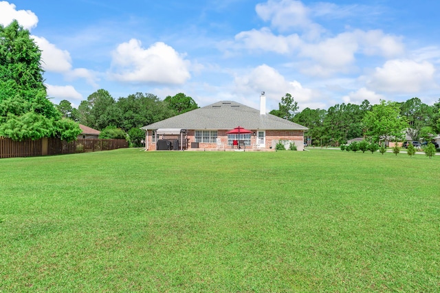 2424 Pineneedle Dr, Navarre, FL 32566 - back of house featuring a patio, brick siding, and a chimney