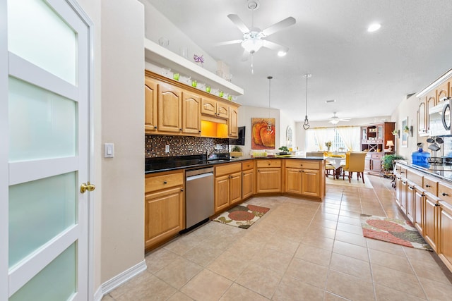 2424 Pineneedle Dr, Navarre, FL 32566 - kitchen featuring stainless steel appliances, ceiling fan, a peninsula, decorative backsplash, and light tile patterned floors