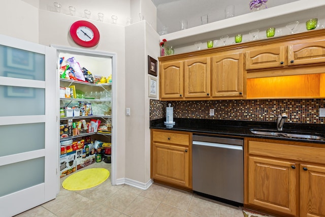 2424 Pineneedle Dr, Navarre, FL 32566 - kitchen with stainless steel dishwasher, light tile patterned floors, decorative backsplash, and dark stone counters