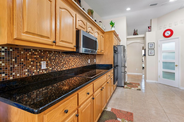 2424 Pineneedle Dr, Navarre, FL 32566 - kitchen featuring stainless steel appliances, tasteful backsplash, light tile patterned floors, dark stone countertops, and recessed lighting