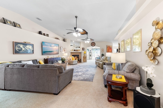 2424 Pineneedle Dr, Navarre, FL 32566 - living room featuring carpet, a ceiling fan, vaulted ceiling, and a lit fireplace