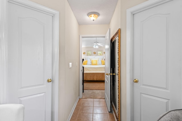 2424 Pineneedle Dr, Navarre, FL 32566 - corridor featuring a textured ceiling and light tile patterned flooring