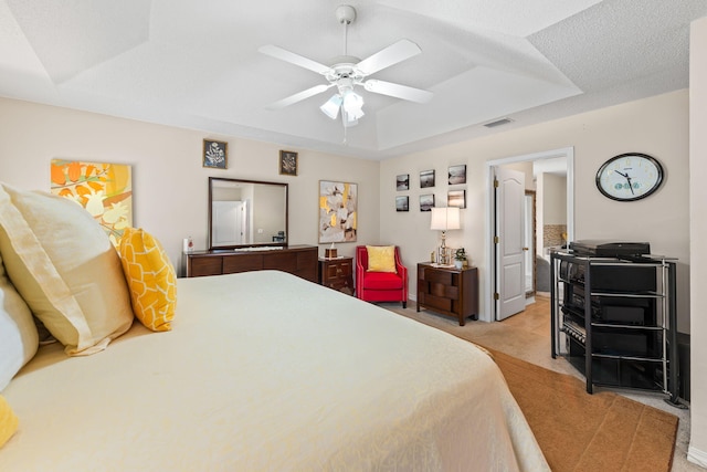 2424 Pineneedle Dr, Navarre, FL 32566 - bedroom featuring a tray ceiling, light carpet, and a ceiling fan