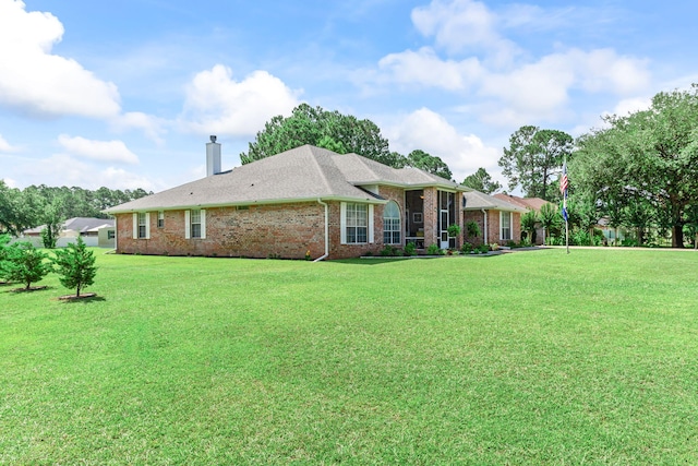 2424 Pineneedle Dr, Navarre, FL 32566 - back of property with a yard, a chimney, and brick siding