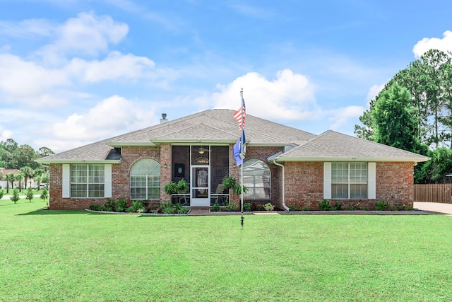 2424 Pineneedle Dr, Navarre, FL 32566 - ranch-style home with brick siding, a sunroom, and a shingled roof