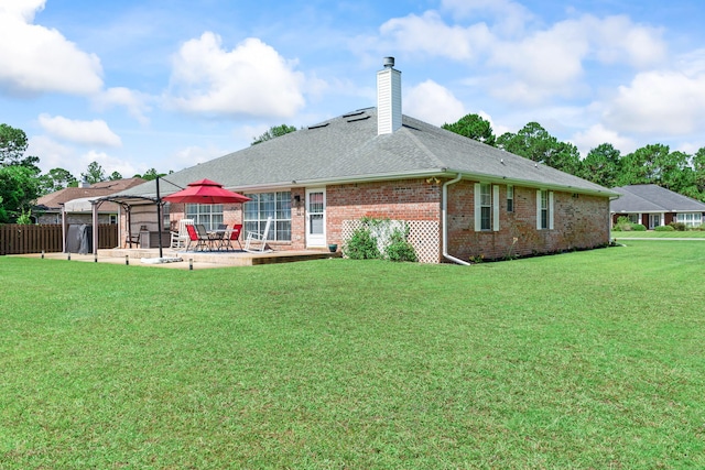 2424 Pineneedle Dr, Navarre, FL 32566 - rear view of house featuring a patio area, a chimney, brick siding, and roof with shingles