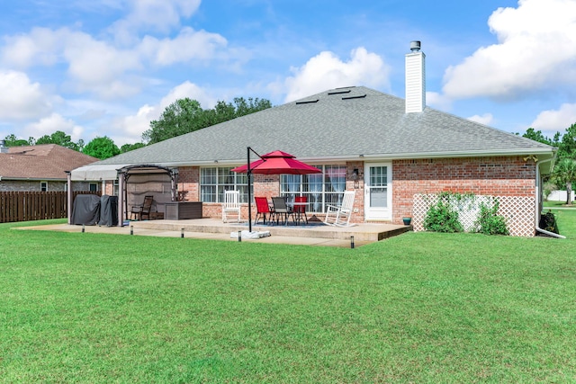 2424 Pineneedle Dr, Navarre, FL 32566 - back of property featuring brick siding, a patio, a chimney, and roof with shingles