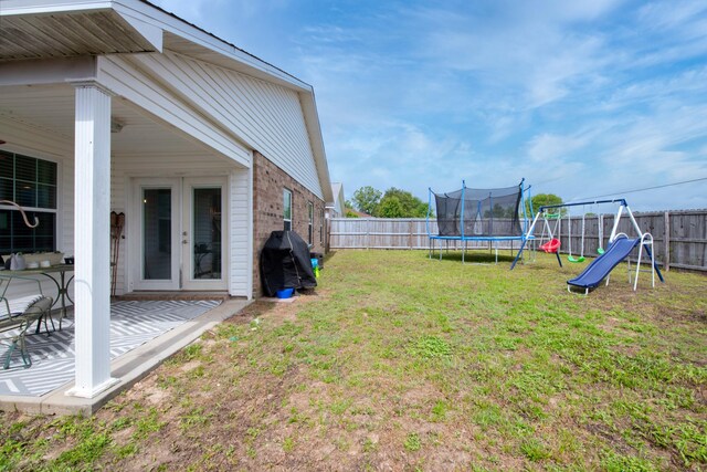 104 Sandstone Trl, Crestview, FL 32539 - view of yard with a trampoline, french doors, and a playground