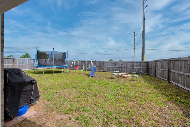 104 Sandstone Trl, Crestview, FL 32539 - view of yard featuring a trampoline and an outdoor fire pit