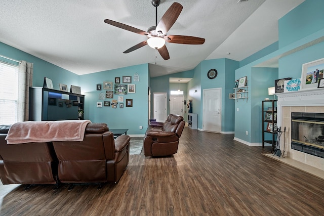 104 Sandstone Trl, Crestview, FL 32539 - living room featuring wood finished floors, a ceiling fan, lofted ceiling, a fireplace, and a textured ceiling