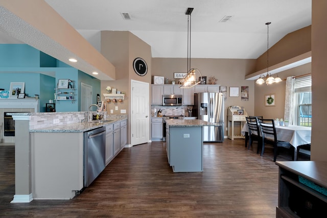 104 Sandstone Trl, Crestview, FL 32539 - kitchen featuring stainless steel appliances, a center island, a sink, a chandelier, and tasteful backsplash