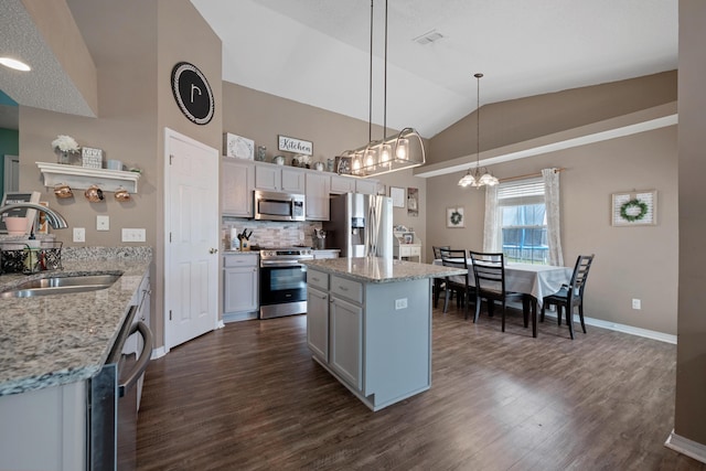 104 Sandstone Trl, Crestview, FL 32539 - kitchen with appliances with stainless steel finishes, a sink, vaulted ceiling, dark wood-type flooring, and a chandelier